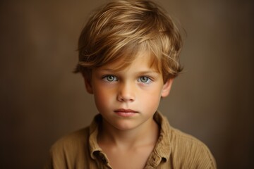 Portrait of a cute little boy with blond hair and blue eyes