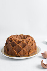 Wall Mural - Vanilla bundt cake on a white tray, homemade bundt cake on a white background