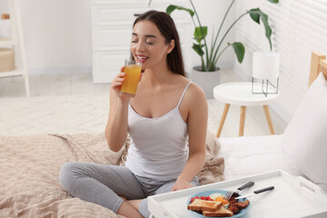 Sticker - Happy young woman having breakfast on bed at home