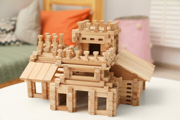 Sticker - Wooden castle on white table indoors. Children's toy