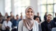 © Krtola  - Muslim middle age business woman in front of a group