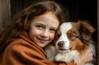 Portrait of a little girl with a dog of breed australian shepherd