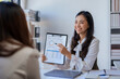 © amnaj - Two happy asian businesswoman talking and consulting working together in the office.