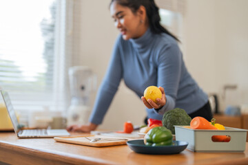 Fat woman cooking in kitchen. health care concept Eat health food to lose weight. Learn to make salads and healthy food from online