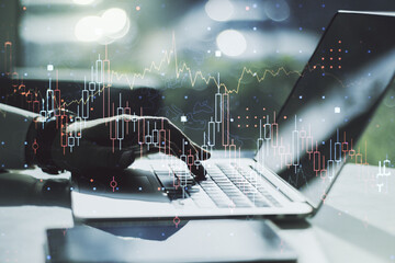 Poster - Abstract creative financial graph with hand typing on laptop on background, forex and investment concept. Multiexposure