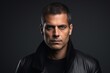 © Inigo - Portrait of a serious man in a leather jacket on a dark background