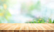 © hakinmhan - Selective focus.Wood table counter on blur flower garden background
