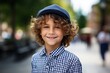 © Inigo - Portrait of a cute little boy with curly hair and blue cap