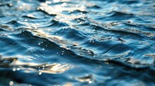  A Close Up Of The Water Surface Of A Body Of Water With Sunlight Reflecting Off Of The Water's Surface.