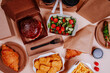 © Westend61 - Salad and fast foods against beige background