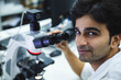 © Westend61 - Smiling scientist near microscope at laboratory