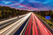 © Westend61 - Germany, Baden-Wurttemberg, Leonberg, Vehicle light trails stretching along Bundesautobahn 8 at dusk