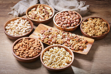 Canvas Print - bowls of mixed nuts on wooden background