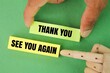 © Fauzi - finger holding colored paper with the words thank you and see you again. the concept of gratitude