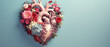 Heart shape made of flowers on blue background, valentines day concept.