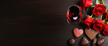 Valentines Day Background With Red Roses, Chocolate Candies And Glass Of Red Wine. Top View With Copy Space.