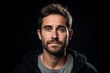 © Inigo - Portrait of a handsome young man with a beard on a black background.