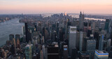 Fototapeta  - Helicopter Tourist Tour Around New York City. Aerial View with a Picturesque Sunset Landscape View Over Manhattan Skyscrapers, with Hudson River and Jersey City