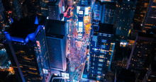 New York Concrete Jungle At Night. Aerial Shot From A Helicopter Tour Around Manhattan. Scenes With Modern Skyscraper Blocking The View On Crowded Times Square Area With Tourists