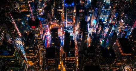 New York Concrete Jungle at Night. Aerial Photo from a Helicopter Tour Around Manhattan. Scenes with Modern Skyscraper Blocking the View on Crowded Times Square Area with Tourists