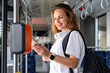 © Barillo_Picture - Urban woman passenger of city public transportation paying bus by her smart phone.