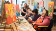© Trendy Graphics - Group of people with intellectual disability painting during group activity