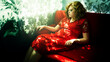 Sensual 30 year old chubby woman reclines to rest on a sofa. she dressed in a red dress.