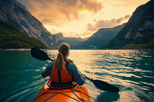 A Beautiful Woman Paddling A Kayak In The Water           