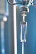 © New Africa - IV drip chamber against blurred light background