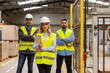 © Halfpoint - Portrait of team of warehouse employees standing in warehouse. Team of workers and female manger in modern industrial factory, heavy industry, manufactrury. Concept of team management.