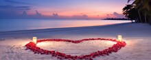 White Sandy Beach, Where Red Rose Petals Have Been Arranged To Shape A Heart, Adding A Touch Of Love To The Serene Coastal Setting.