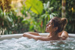 © kazakova0684 - Young woman enjoying a relaxing holiday in a jacuzzi. relaxation and comfort during water procedures.