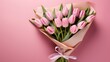 Pink paper wrapper with a bouquet of tulips.