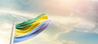 Gabon national flag cloth fabric waving on the sky - Image