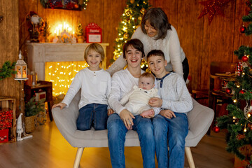 Poster - Happy family, newborn baby and older brothers, mom at home on Christmas