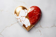 Golden, red and white broken heart made of marble.