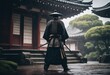 A epic samurai with a weapon sword standing in front of a old japanese temple shrine rainy day