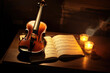 © pilipphoto - Old violin at the table with books and candles, still life