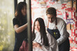 © chokniti - Asian Hairdresser giving treatment and barber occupation service, Professional hairstylist combing and using scissors cut woman's hair to young beautiful customer girl in beauty salon