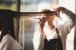 © chokniti - Asian Hairdresser giving treatment and barber occupation service, Professional hairstylist combing and using scissors cut woman's hair to young beautiful customer girl in beauty salon