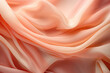 Abstract peach background. peach fabric texture background. peach silk satin. Curtain. .Shiny fabric. Wavy fold. Soft peach fabric folds texture.Fashion and luxury textile design.