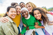 © Davide Angelini - Multi ethnic group of young women hugging outside - Happy girlsfriends having fun laughing out loud on city street - Female community concept with cheerful girls standing together - Women  power