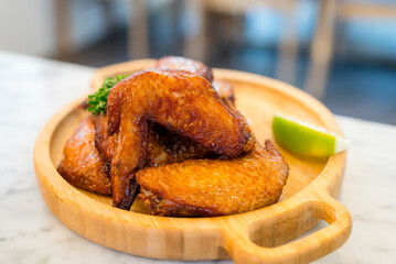 Poster - Deep fried chicken wing on wooden plate