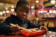 African Boy Eats Sushi In Diner