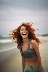 Wall Mural - attractive red-haired woman enjoying on the beach