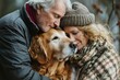 an attractive middle-aged couple hugs their old dog
