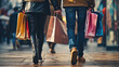 Close-up of the lower half of two shoppers walking with multiple colorful shopping bags in their hands