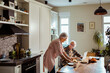 © Marko Geber - Elderly couple enjoying breakfast and laptop time together at home