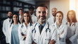 A male doctor with a friendly smile stands at the center of a group of medical professionals, highlighting leadership and trust. Welcoming vibe, suitable for community health center promotions.