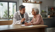 © SkyLine - A compassionate male doctor is seen in conversation with an elderly female patient at a home setting, depicting personalized and attentive medical care outside the traditional clinical environment